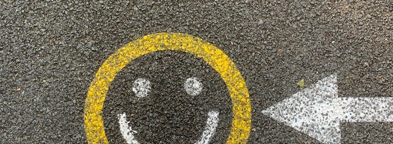 Smiley und Pfeil auf Beton